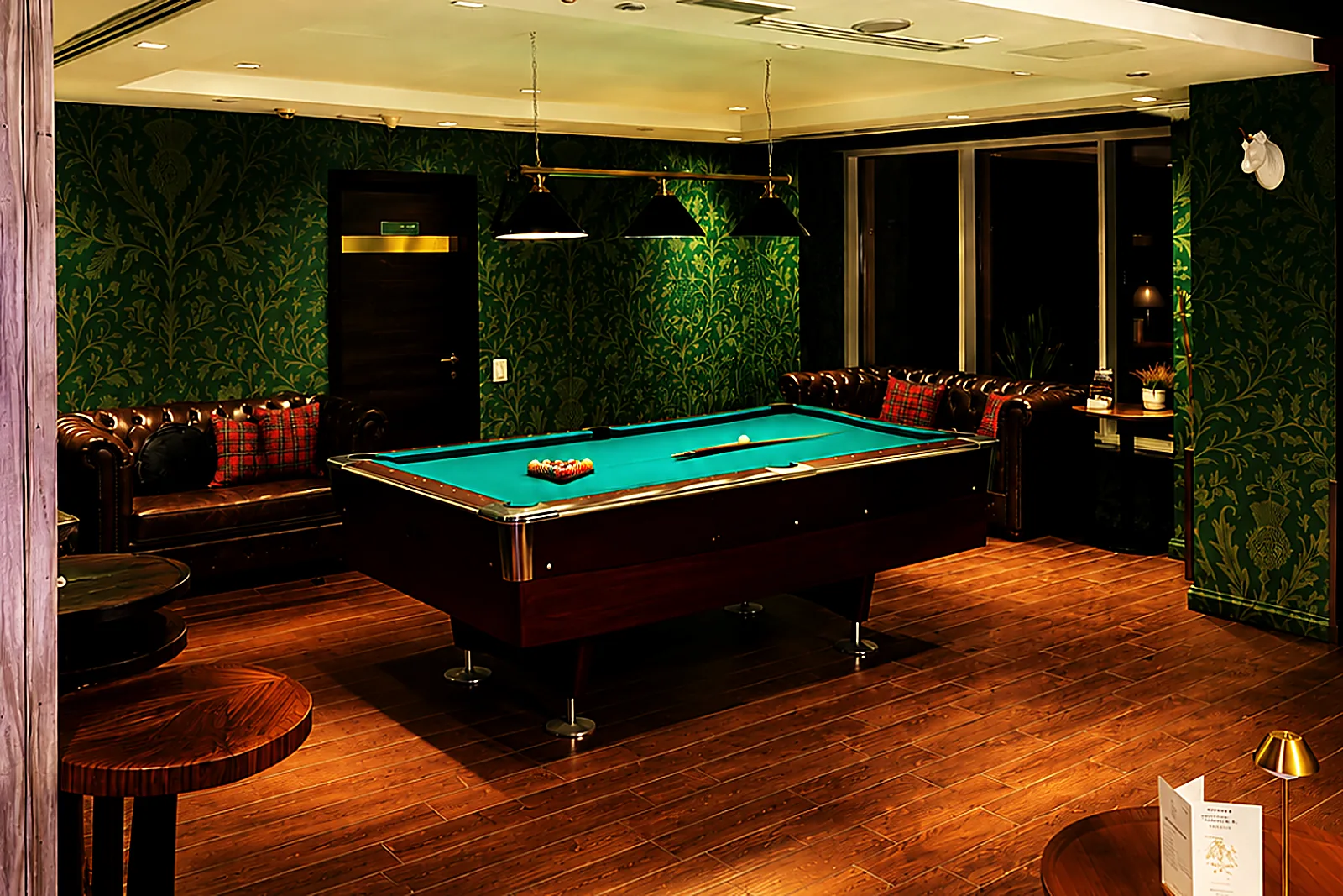 The green-walled games room with the billiards table