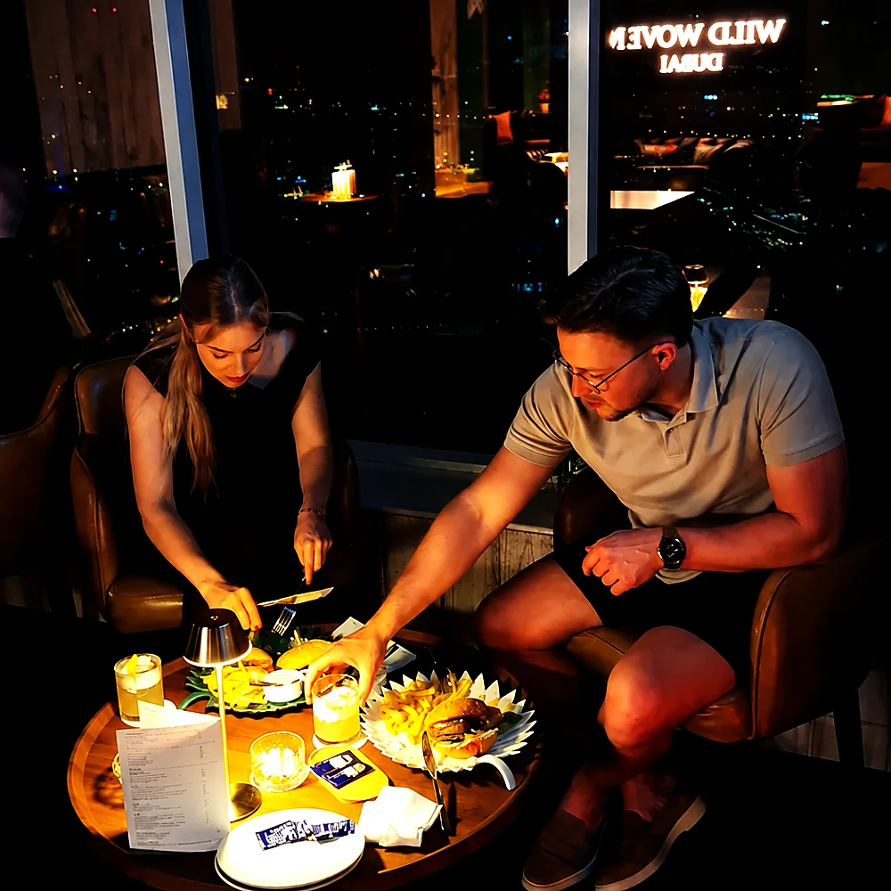 Two guests talking over sharing plates at a Wild Woven table