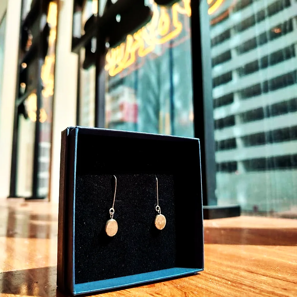 Boxed earrings displayed against the window