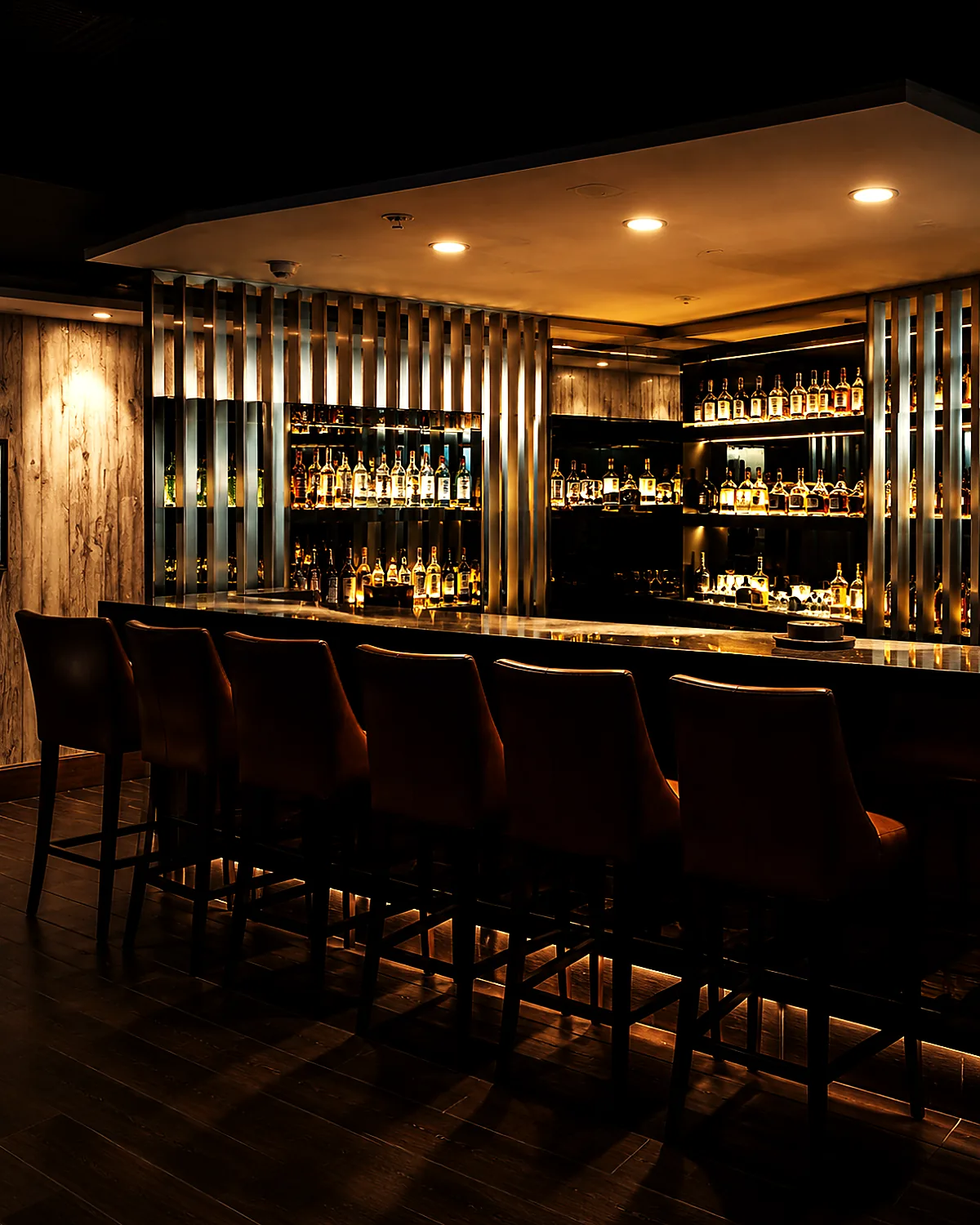 The Wild Woven bar, backlit bottles and leather stools